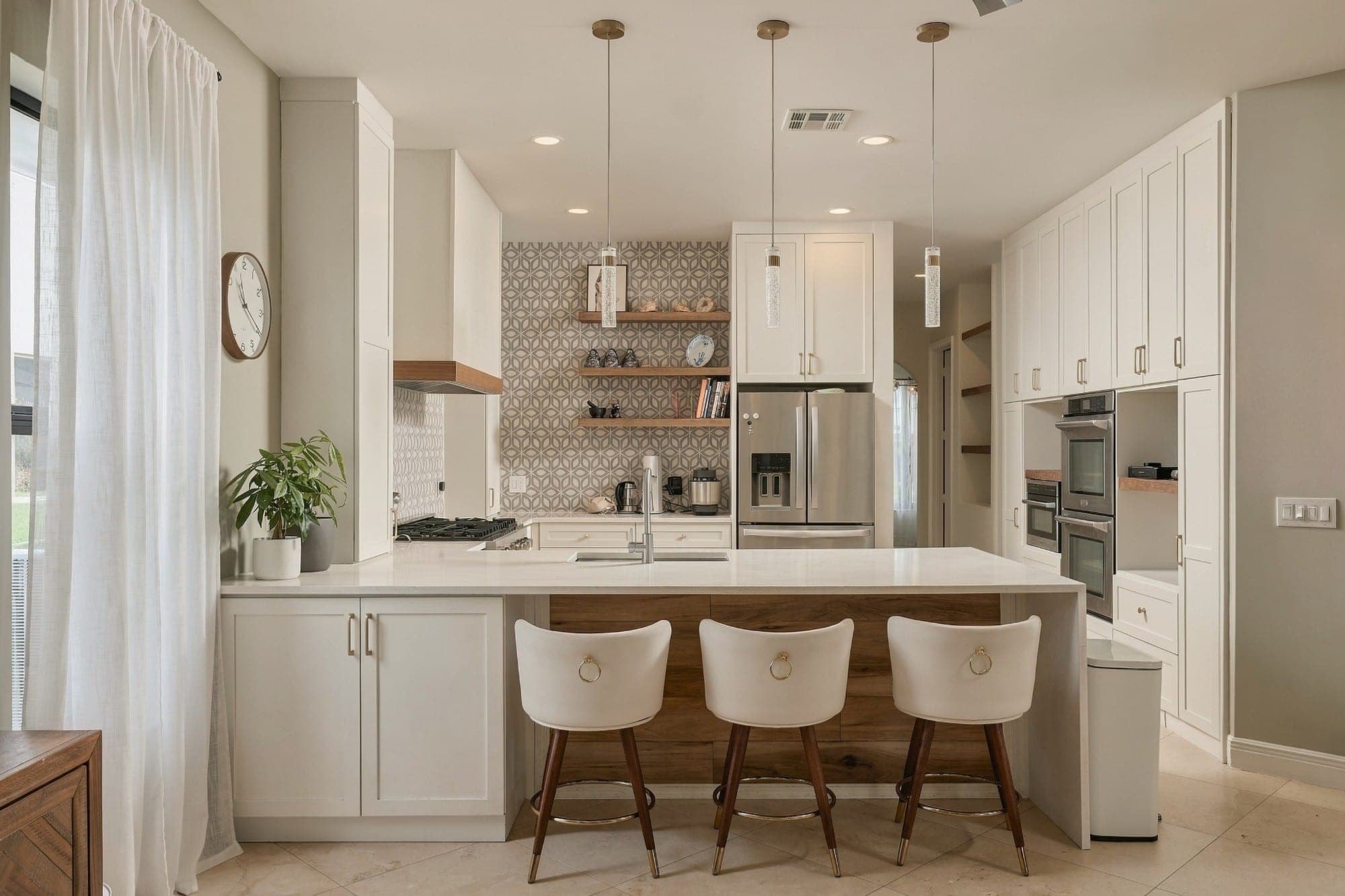 White shaker kitchen with a geometric tile backsplash and walnut range hood