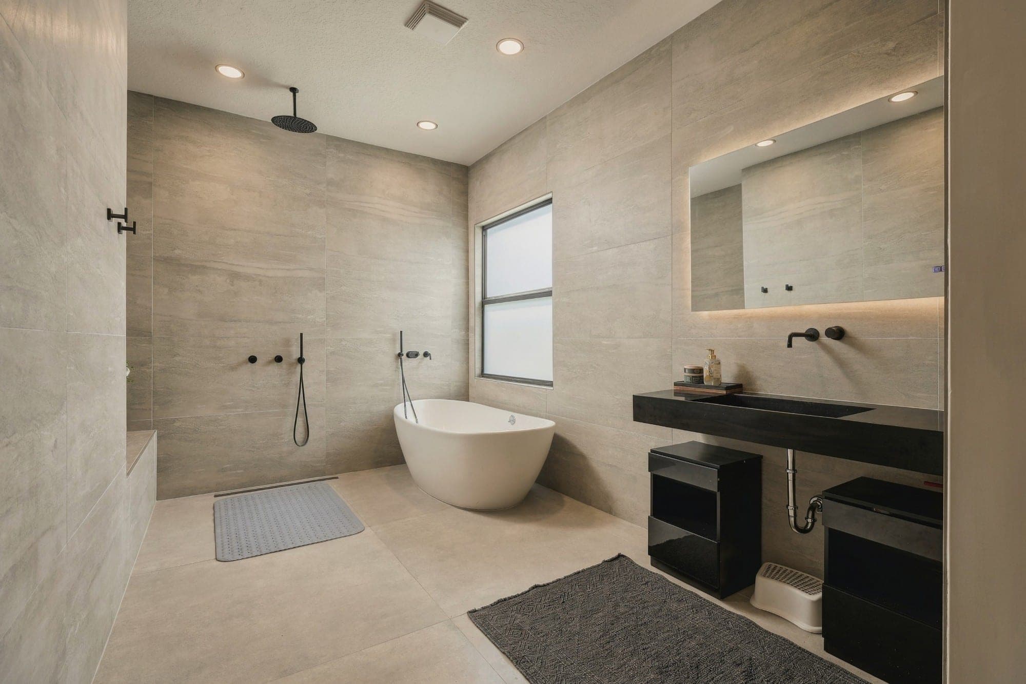 Bathroom with a wet-room shower, freestanding tub and floating vanity