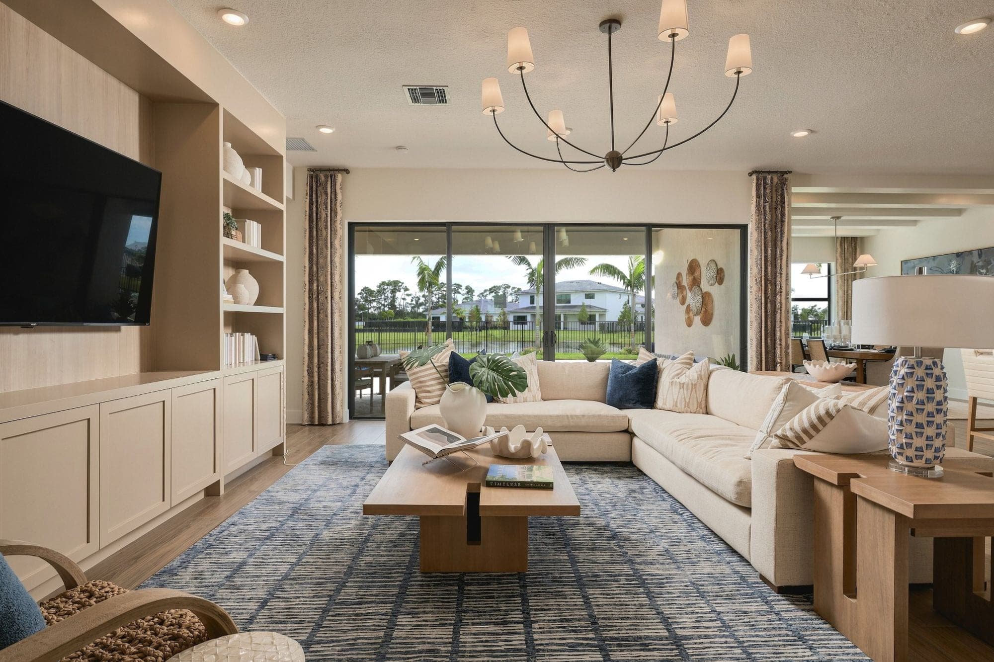 Living room with built-in shelving and a sliding glass wall onto the lake